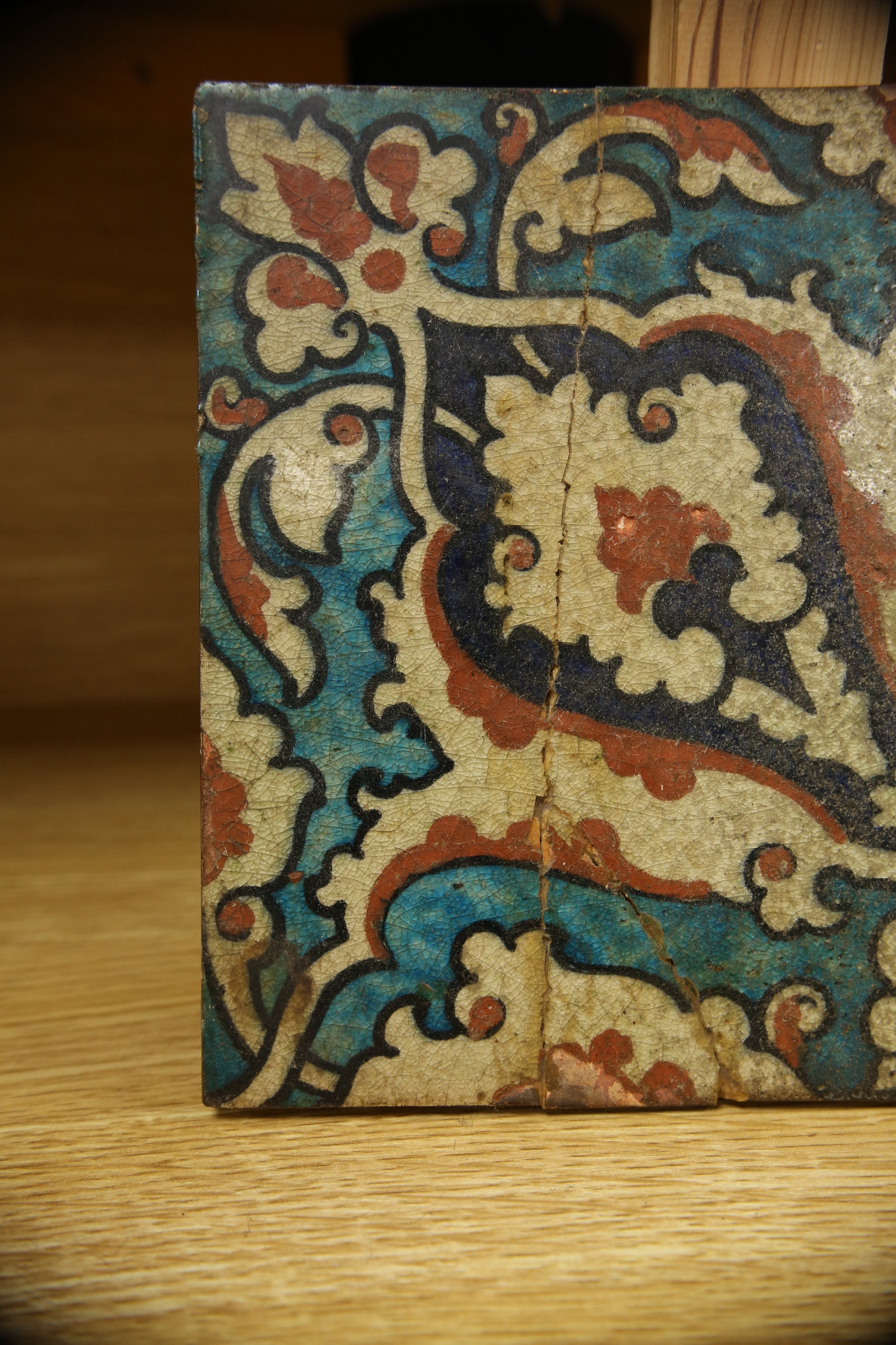 A 17th century style Iznik pottery tile, 20.5cm sq. Condition - poor